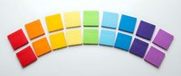 Colorful sticky notes arranged in rainbow spectrum arc on white surface, representing organization, planning, creativity and communication for business, education and office projects.