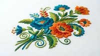 Colorful embroidered floral arrangement with blue and orange flowers, green leaves and decorative swirls on white background, isolated for textile and craft design projects.
