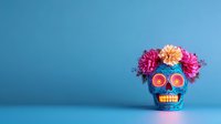 Blue decorative skull with pink and orange flowers on top and glowing orange eyes against blue background, Day of the Dead traditional Mexican celebration symbol.