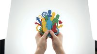 Hands holding colorful paper cutout figures representing diversity, teamwork and community unity on white background for social concepts.