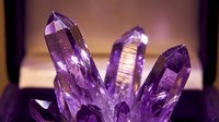 Purple amethyst crystal cluster with faceted points and natural formations on warm background for healing and spiritual practices.