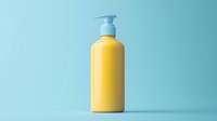 Yellow plastic pump bottle container on light blue background, minimalist product photography style for cosmetic and personal care marketing. Isolated object.