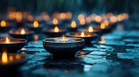 Glowing oil lamps creating warm light during heavy rainfall on wet stone surface. Atmospheric scene with bokeh lights and water droplets for meditation concepts.
