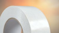 White adhesive tape roll close-up on warm background for repair and construction projects.