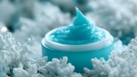 Luxurious turquoise face cream jar nestled in crystalline frost formations, showcasing premium skincare product with soft, whipped texture for beauty and cosmetic marketing.