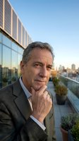 Mature male professional in business suit posing thoughtfully on urban rooftop with city skyline and modern glass building backdrop, suitable for corporate portraits.