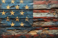 Weathered American flag painted on rustic wooden planks showing distressed texture and peeling paint, creating vintage patriotic wall art effect.