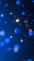 Abstract blue background with glowing orange and blue bokeh circles floating in dark space, creating magical night sky atmosphere. Suitable for festive designs.