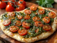 Fresh homemade pizza topped with vibrant pesto sauce and sliced cherry tomatoes on rustic wooden board, showcasing Italian culinary artistry and fresh ingredients.