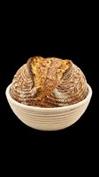 Rustic sourdough bread loaf in a proofing basket, isolated on transparent background, ready for bakery clipart, t-shirt design, stickers, and print on demand use.