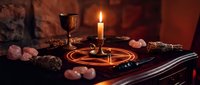 Mystical altar setup with pentagram, candles, crystals and ritual tools for spiritual practices, witchcraft ceremonies and occult meditation sessions.