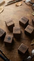 Wooden blocks with EMDR letters on rustic desk with glasses and pen for therapy and mental health treatment concept.