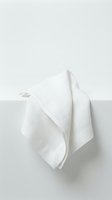White linen kitchen towel hanging on hook against neutral wall background for home decor and cooking concepts.