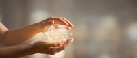 Hands holding glowing light sphere, symbolizing energy, innovation, and future technology concepts for business and creative projects.