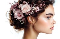 Young woman with natural makeup in profile view wearing pink roses and baby's breath flowers in her dark updo hairstyle against white background.