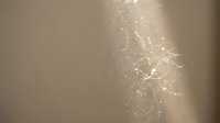 Abstract golden light particles floating with magical sparkles and glowing effects on warm beige background for luxury design projects.