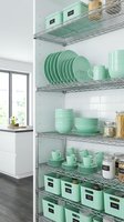 Modern kitchen pantry organization with mint green dinnerware and storage containers on chrome wire shelving for home organization and interior design.