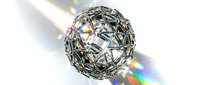 Crystal sphere with prismatic light reflections creating rainbow spectrum effects on white background for luxury design projects.