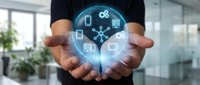 Business professional holding glowing digital brain with technology icons representing artificial intelligence and innovation in modern office environment.