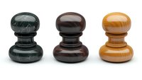 Wooden chess pawns in black, brown and light brown colors arranged in row on white background, polished surface with natural wood grain texture showing.