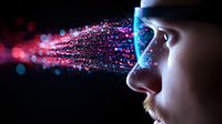 Young caucasian man profile with glowing particles streaming from eyes into dark space, representing virtual reality, digital transformation and artificial intelligence technology.