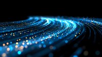 Glowing blue wave of digital particles flowing on black background creates futuristic technology visualization with bokeh light effect and motion blur.