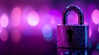 Metallic padlock with water drops illuminated by neon purple and blue lights against defocused bokeh background, concept of digital security and data protection.