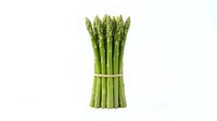 Fresh green asparagus spears bundled together with white twine, isolated on white background. Suitable for culinary, food, nutrition, cooking, and healthy eating design projects.