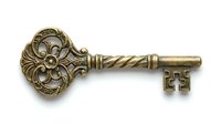 Ornate antique brass skeleton key with decorative floral head and twisted shaft, isolated on white background for design, clipart, and vintage decor projects.