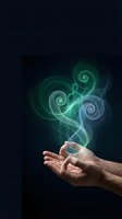 Open hands releasing glowing green and blue spiral energy swirls against dark background for spiritual healing and meditation concepts.