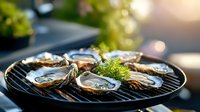 Fresh oysters on black grill plate garnished with dill and lemon, soft natural lighting creates gourmet atmosphere for seafood restaurant menu and food photography.