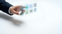 Businessman hand holding transparent digital interface with holographic app icons and data visualization for technology and business solutions.