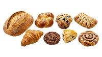 Assorted fresh baked goods including artisan bread, croissants, pastries and rolls isolated on white background for bakery, food service and culinary design projects.
