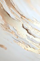 Abstract fluid art background with white and gold metallic paint strokes creating luxurious marble effect texture for elegant design projects.