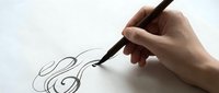 Hand drawing elegant musical treble clef symbol with black pen on white paper. Creative music notation sketch for educational materials and artistic projects.