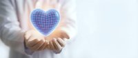 Businessman holding glowing blue digital heart with grid pattern symbolizing healthcare technology, telemedicine, and medical innovation concepts.