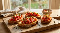 Toasted bread slices topped with fresh tomatoes, herbs and olive oil on wooden board, ready for serving as appetizers or bruschetta snacks.