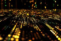Abstract digital technology background with glowing golden particles and bokeh lights creating futuristic data visualization for tech presentations.