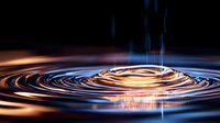 Mesmerizing water drop impact creating golden and blue circular ripples on dark liquid surface with dramatic lighting effects and reflective waves.