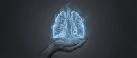 Silhouette of hand holding glowing lungs on dark background for healthcare, medical education, respiratory disease awareness, and wellness concepts.