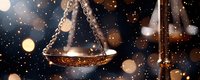 Antique brass scales of justice with glowing bokeh lights and sparkles on dark background, symbolizing law, judgment and legal proceedings.