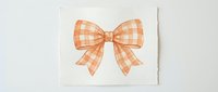 Orange gingham checkered bow ribbon isolated on white background for gift wrapping, crafts, scrapbooking and decorative design projects.