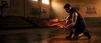 Young athletic man dribbling basketball in dramatic sunlit gym with golden hour lighting creating intense sports training atmosphere.