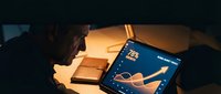 Young African American man analyzing data charts on tablet screen in warm evening light showing business analytics and financial growth metrics.