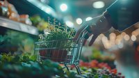 Fresh herbs in miniature shopping cart at grocery store produce section with bokeh lights creating warm atmospheric shopping experience.