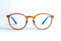 Modern round eyeglasses with orange metallic frame and blue temple tips on white background, isolated optical accessory for vision correction and style.