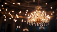 Elegant crystal chandelier with warm glowing lights against blurred bokeh background, creating luxurious ambiance for events and interior design.