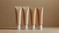 Neutral beige cosmetic tubes arranged in row on monochrome background. Minimal product photography for beauty and skincare packaging mockup presentation.