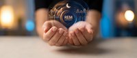 Hands holding glowing REM sleep cycle icon with brain wave visualization, representing sleep quality monitoring and circadian rhythm management for wellness applications.