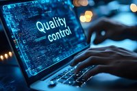 Digital quality control system on laptop screen with hands typing in dark environment with blue technology interface.
